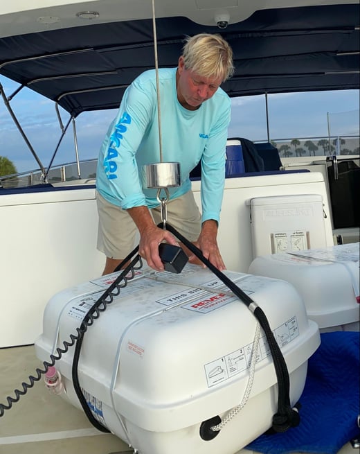 RV ANGARI Captain prepares life rafts for recertification